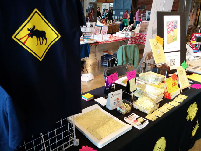 My table at VanCAF, featuring new Laser Moose t-shirts!